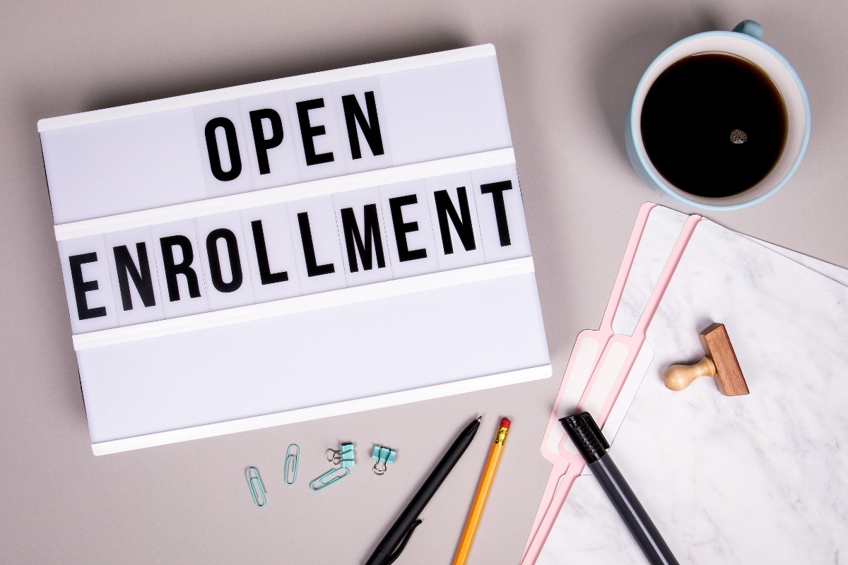 open enrollment sign with planning papers and materials